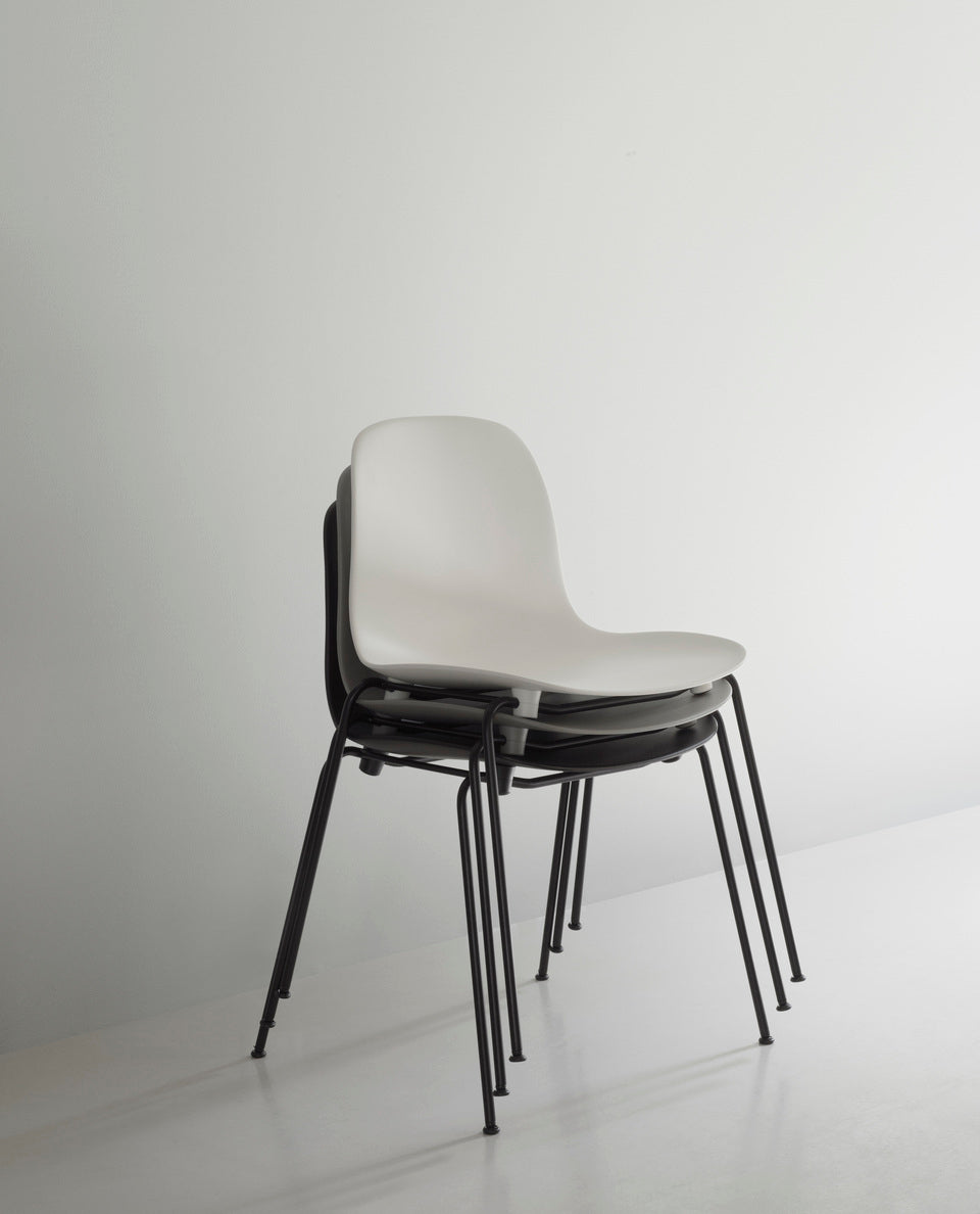 Red stacking chair with a black base