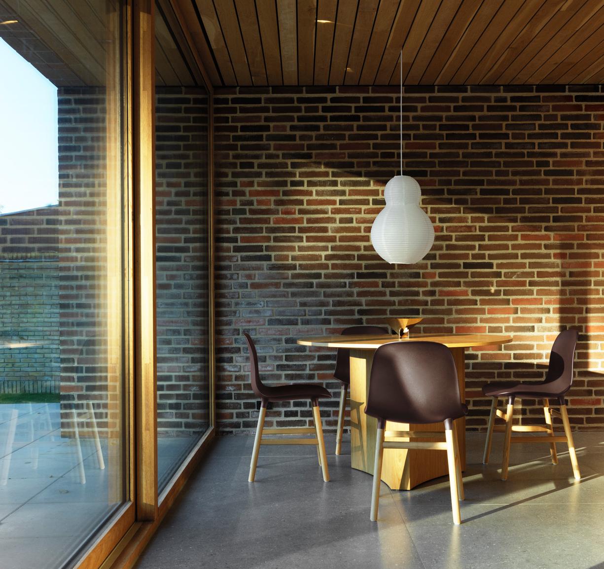 A chair of green forms with an oak base