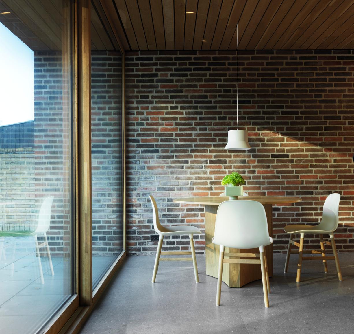 A chair of green forms with an oak base