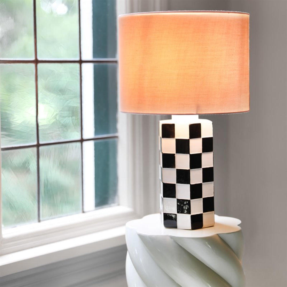 CHECK black-and-white table lamp with a pink shade