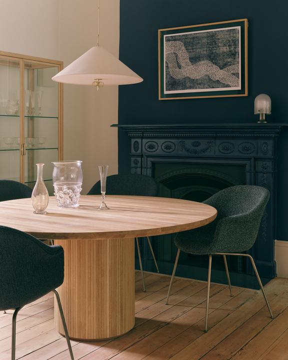 Upholstered BAT chair with a black metal base