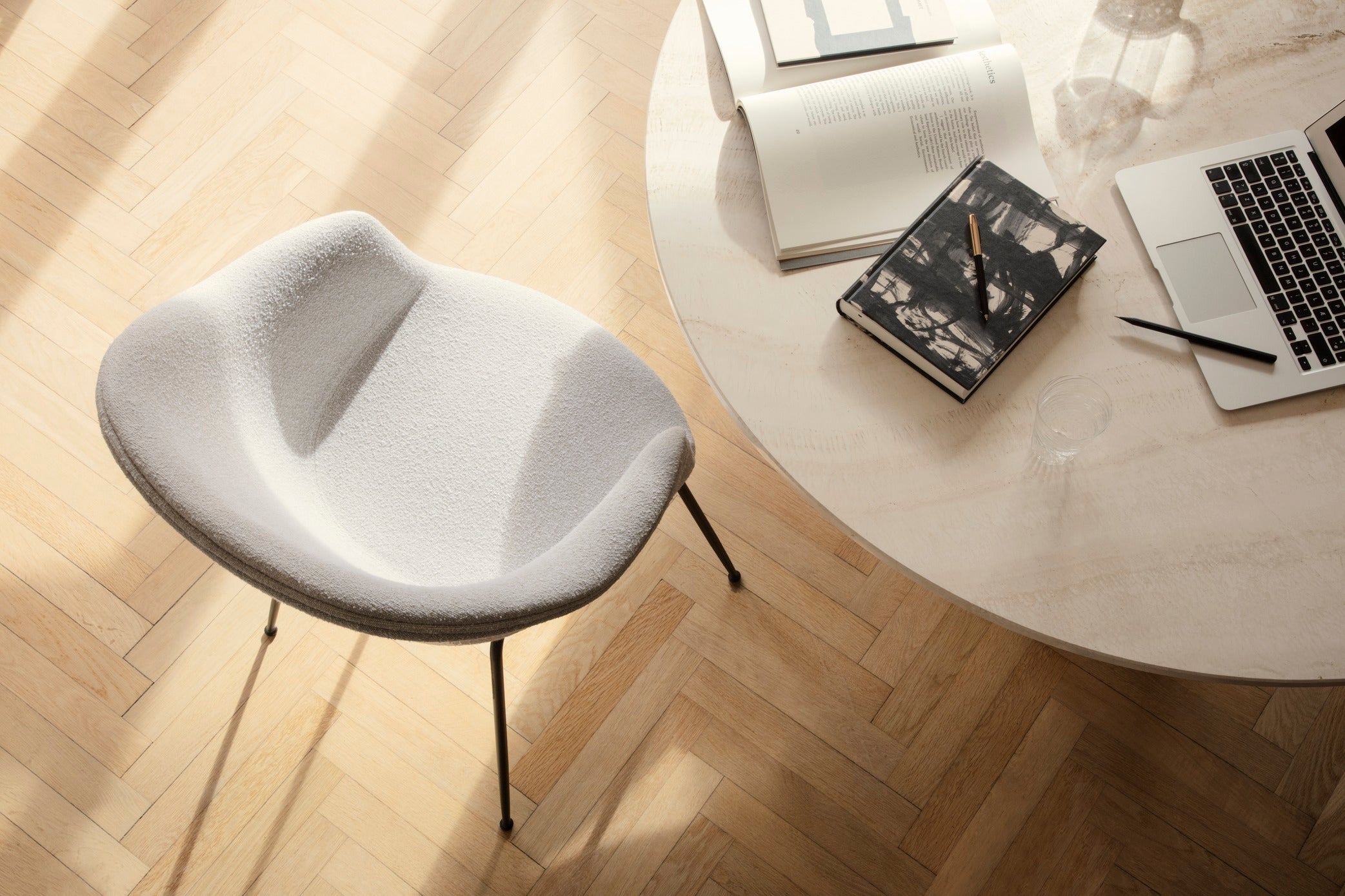 Upholstered BAT chair with a black metal base