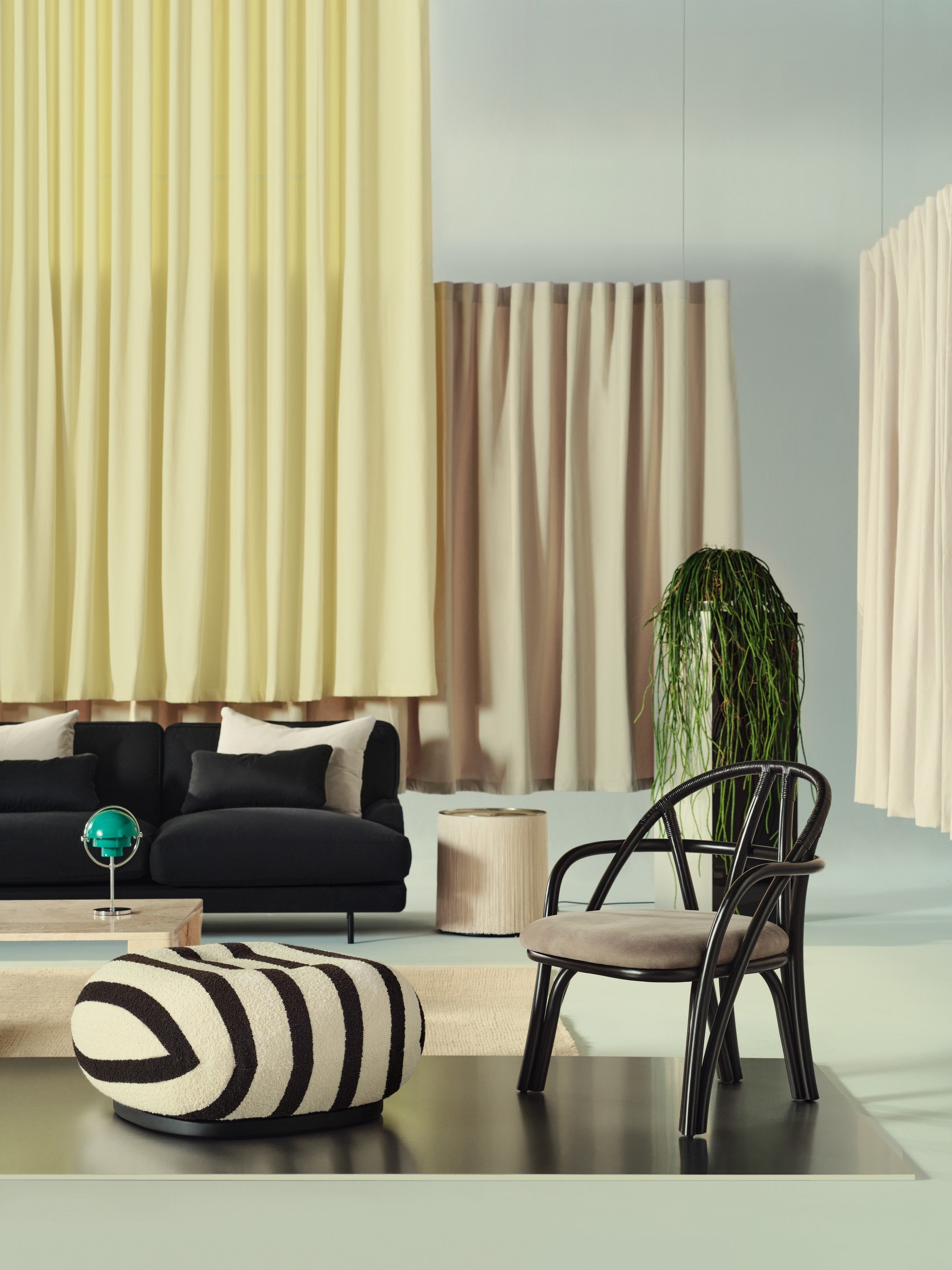 PACHA upholstered pouf with black base