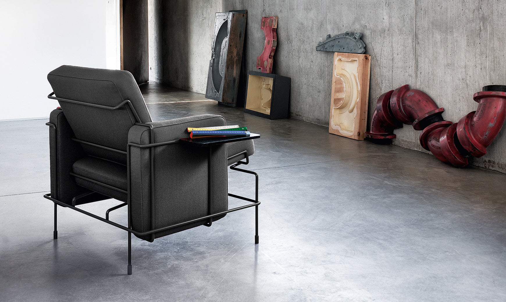 TRAFFIC upholstered armchair with a black steel base