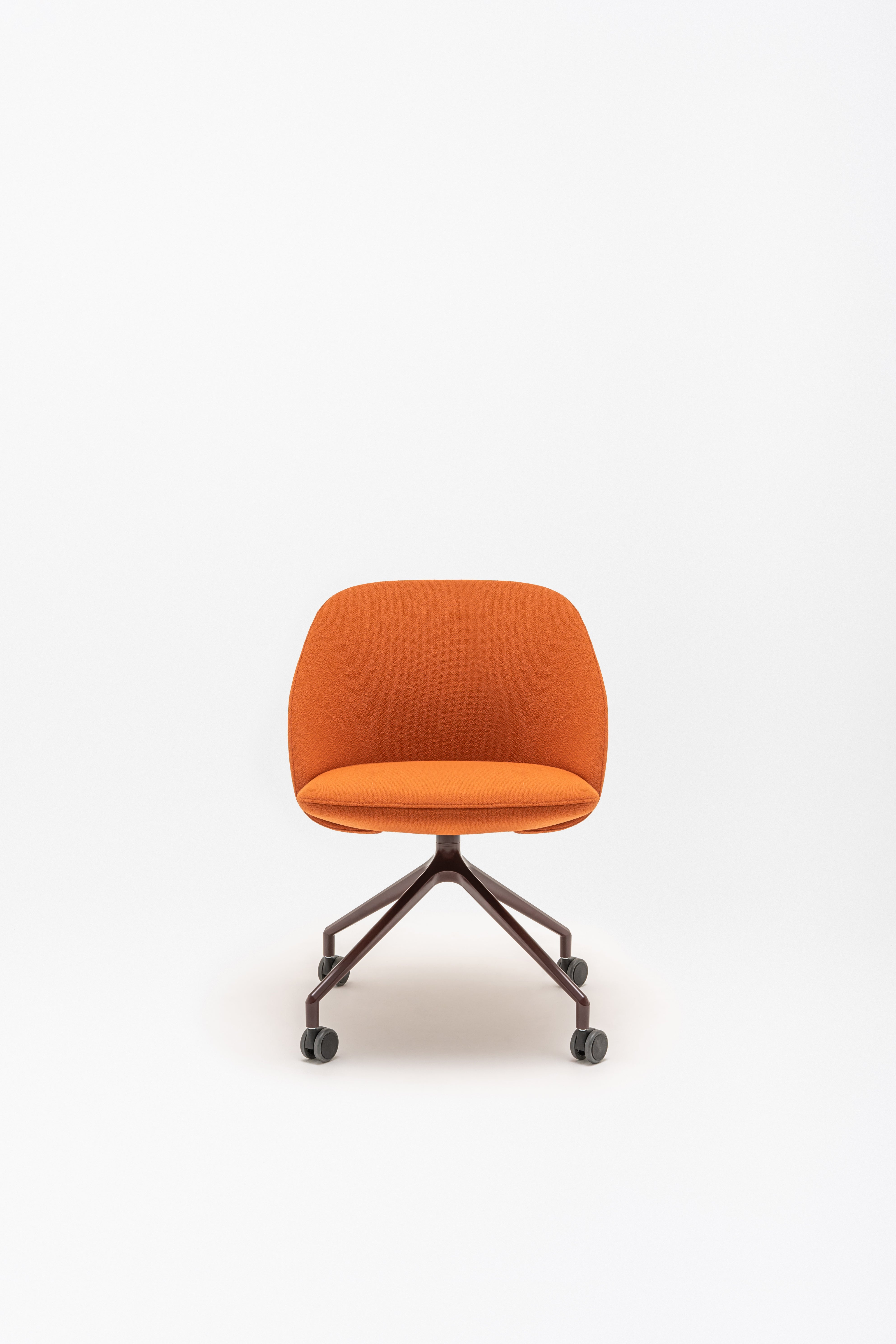 Rotable armchair with low backrest metal parallel base with wheels to a soft surface