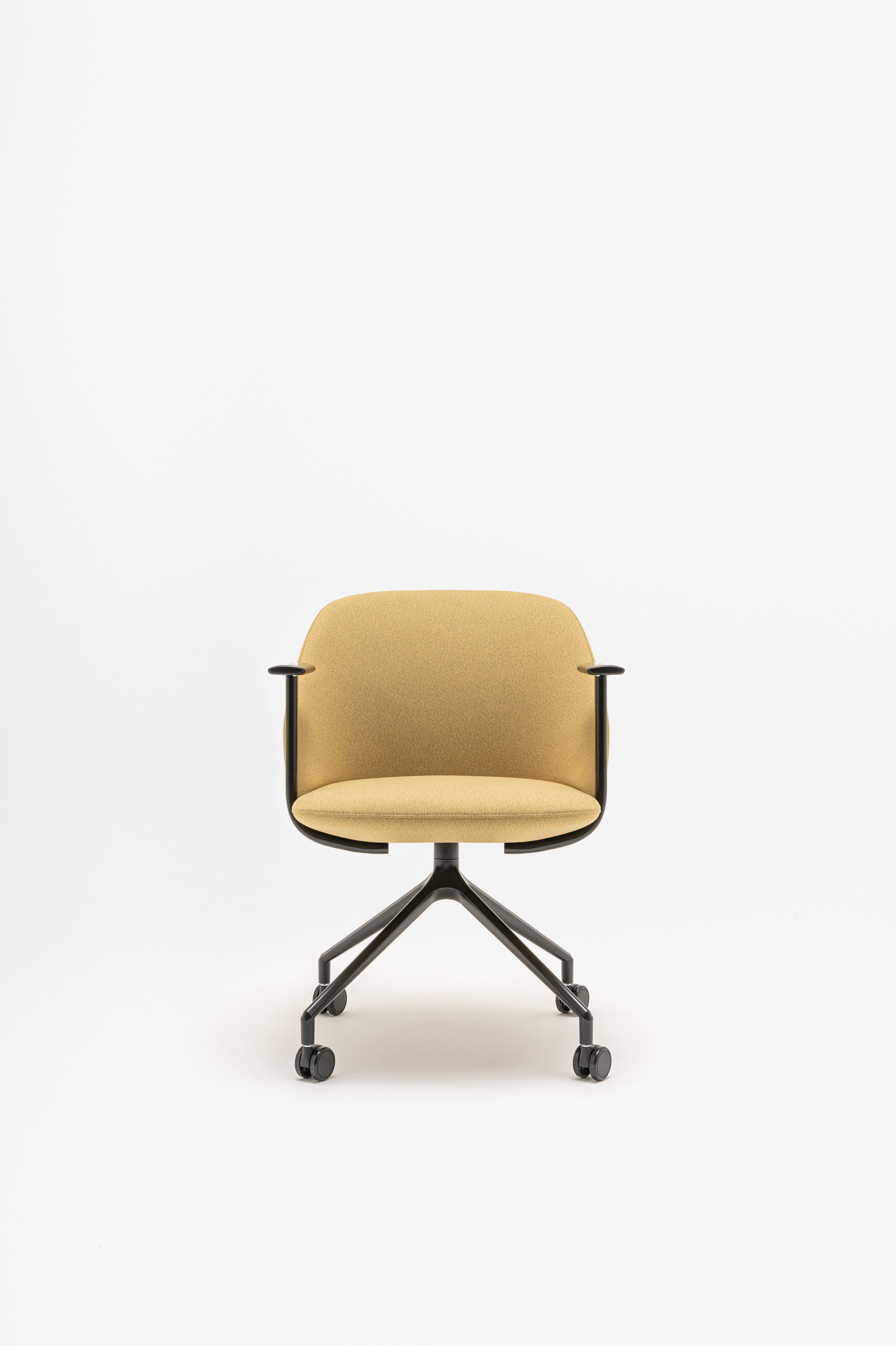 Rotable armchair with low backrest metal parallel base with wheels to a soft surface