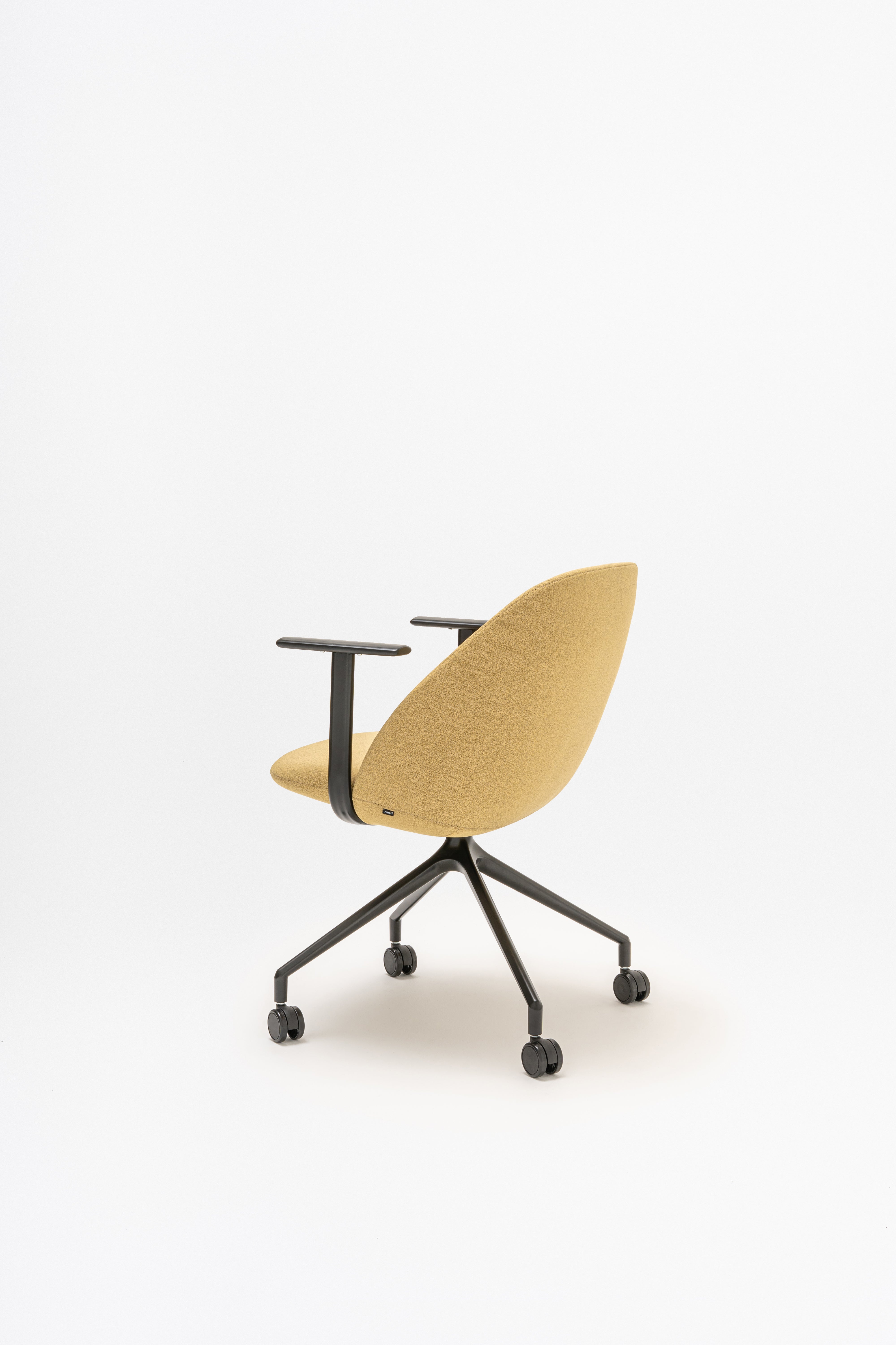Rotable armchair with low backrest metal parallel base with wheels to a soft surface