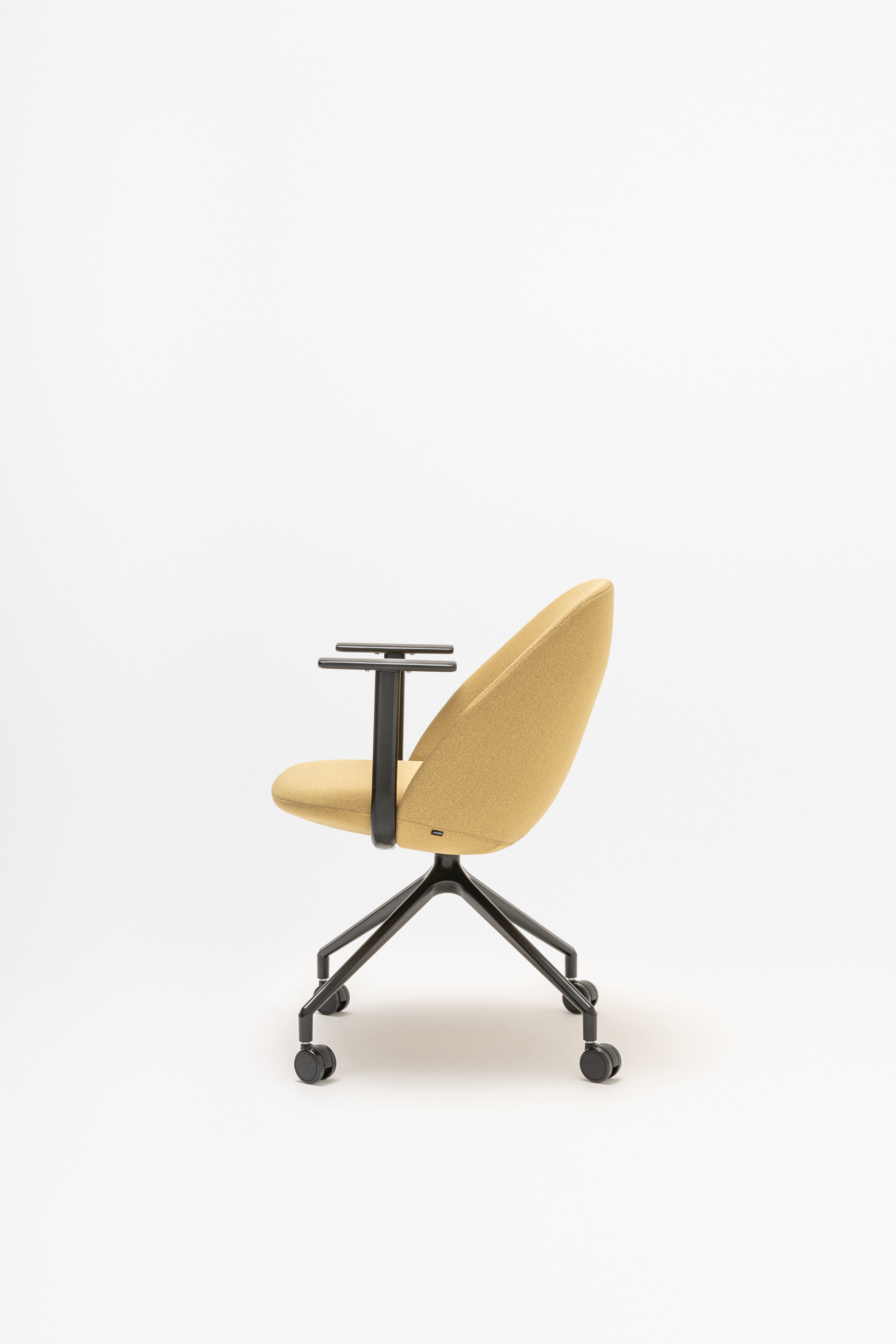 Rotable armchair with low backrest metal parallel base with wheels to a soft surface