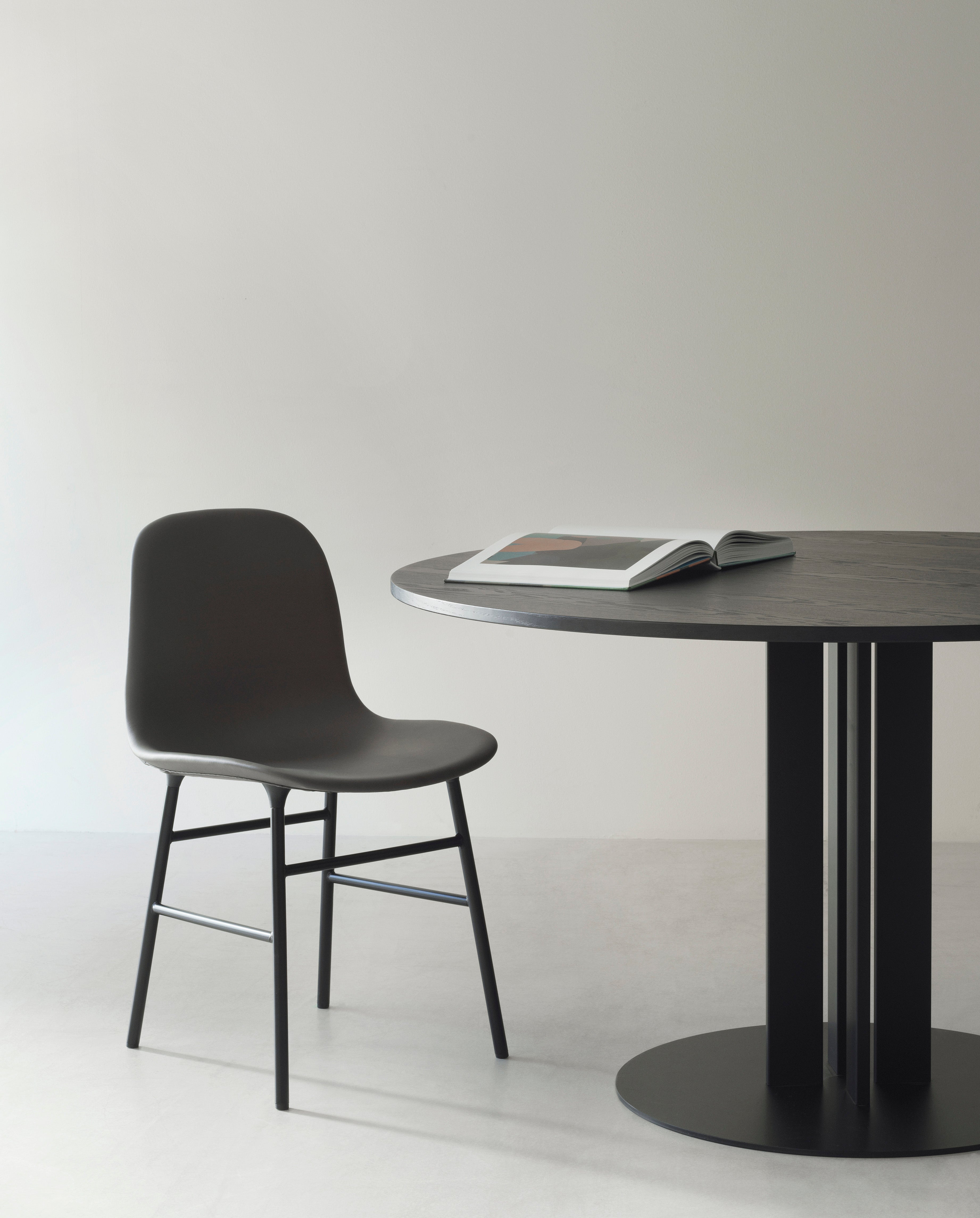 A chair of brown forms with a golden base