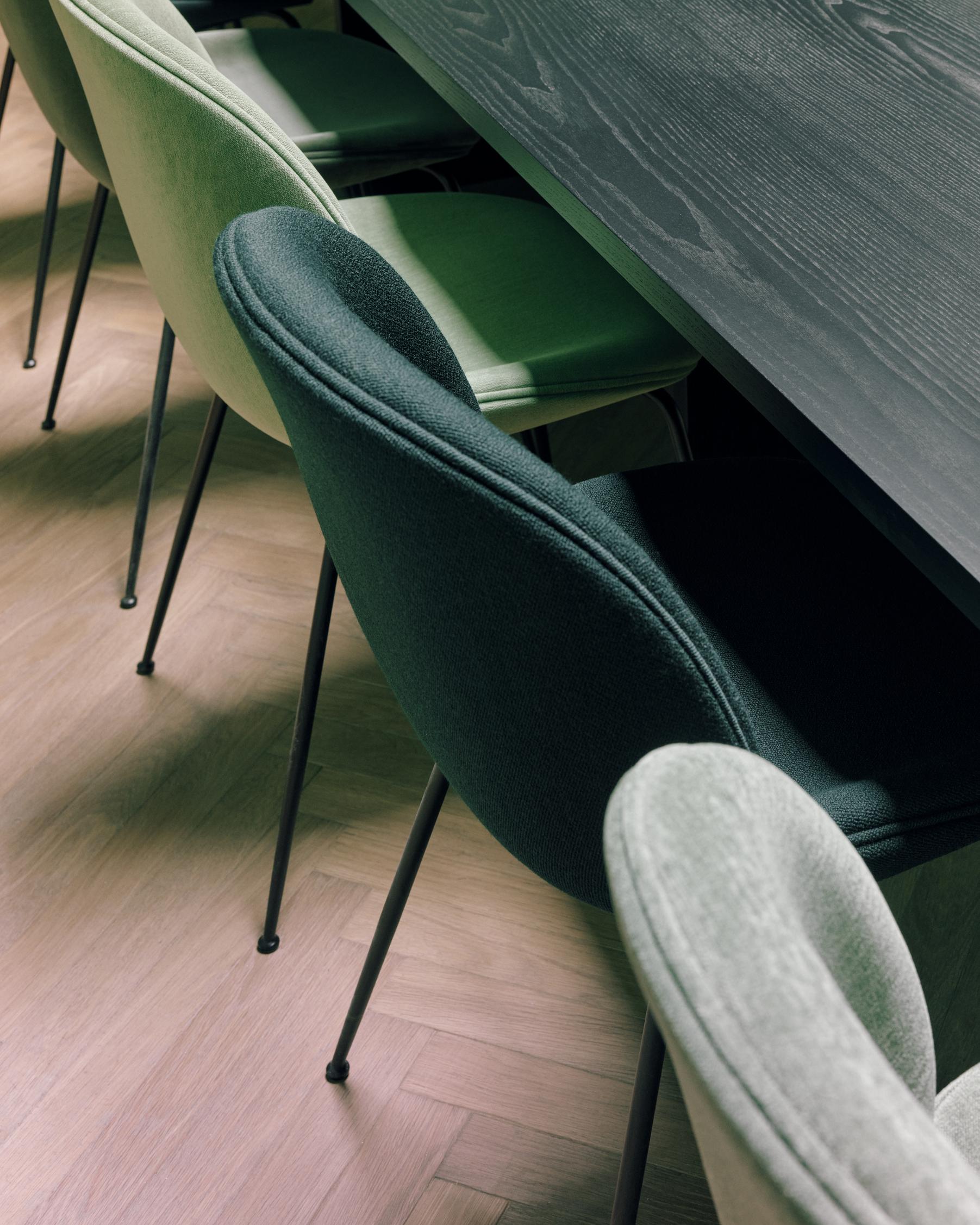 BEETLE upholstered chair with a black base