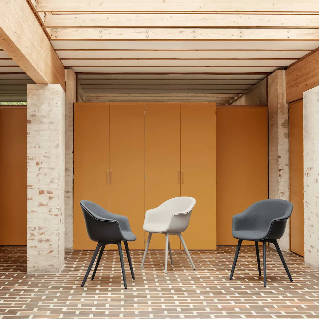 BAT chair in dark gray with a metal base