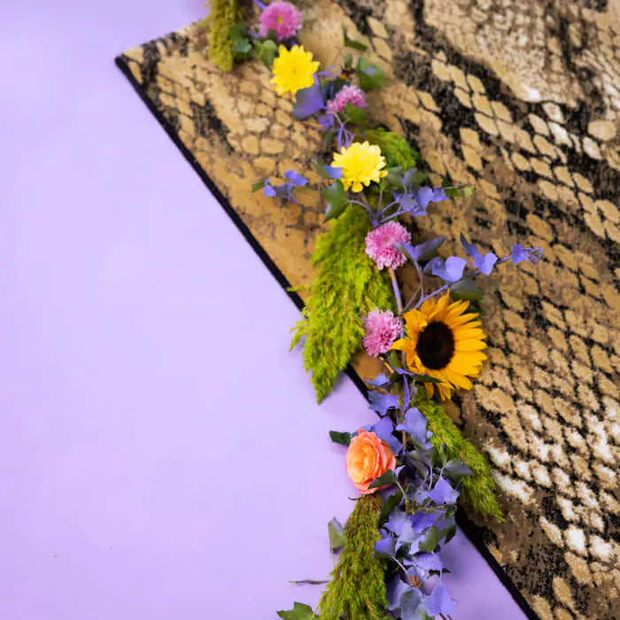 KEEP YOUR ENEMIES CLOSER rug in brown snake print