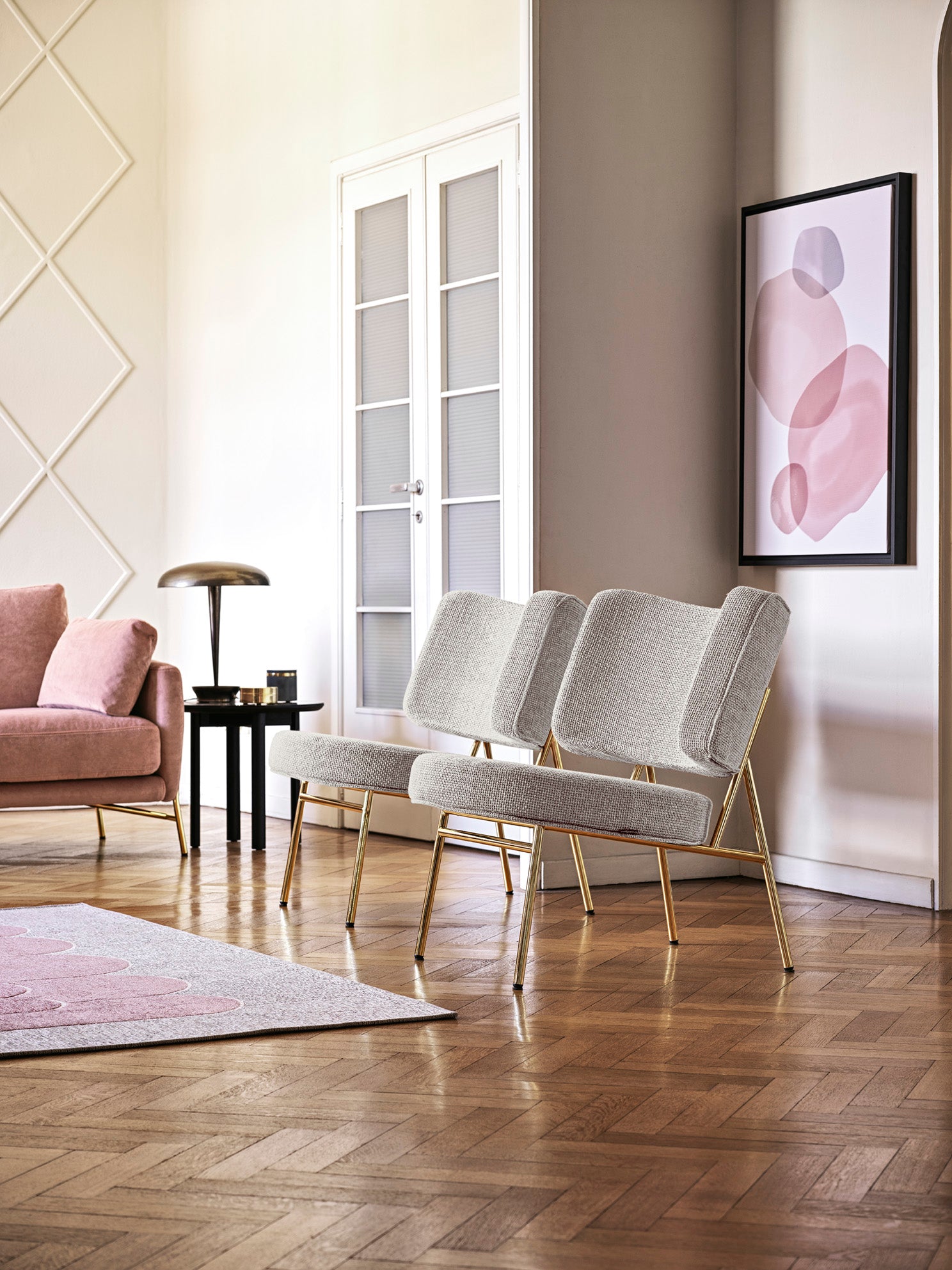 Upholstered COCO armchair with a golden base