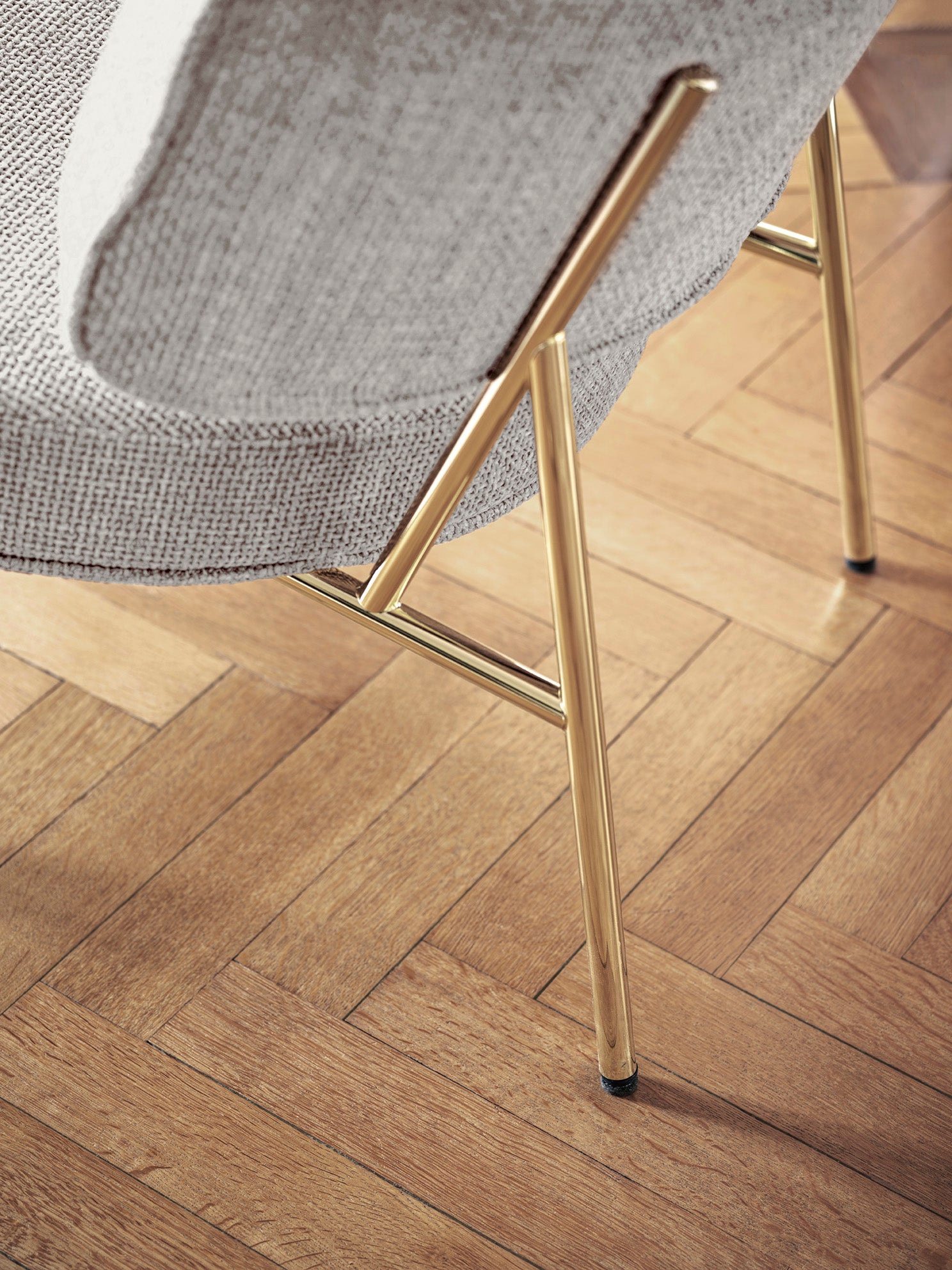 Upholstered COCO armchair with a golden base