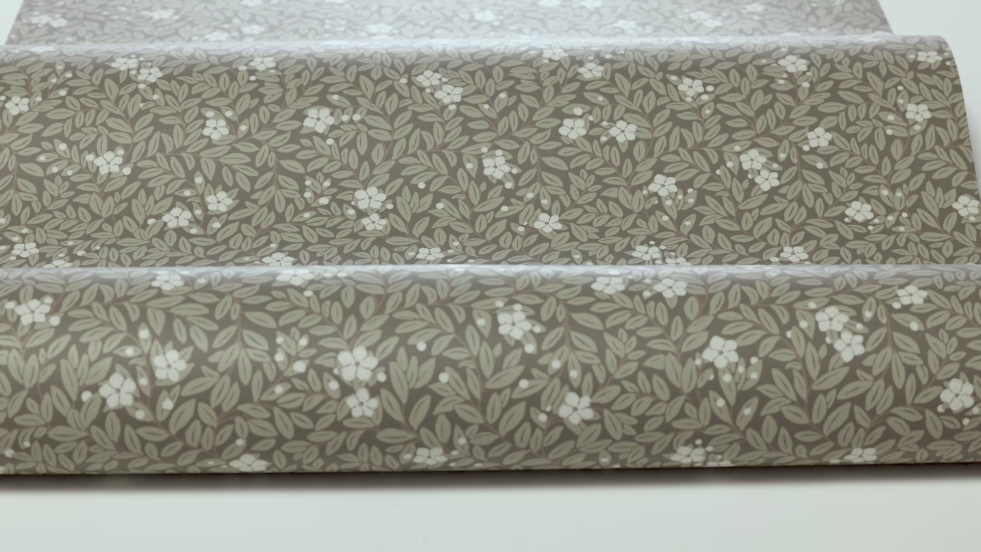 Brown MYRTEN wallpaper with a floral pattern of flowers and leaves in white