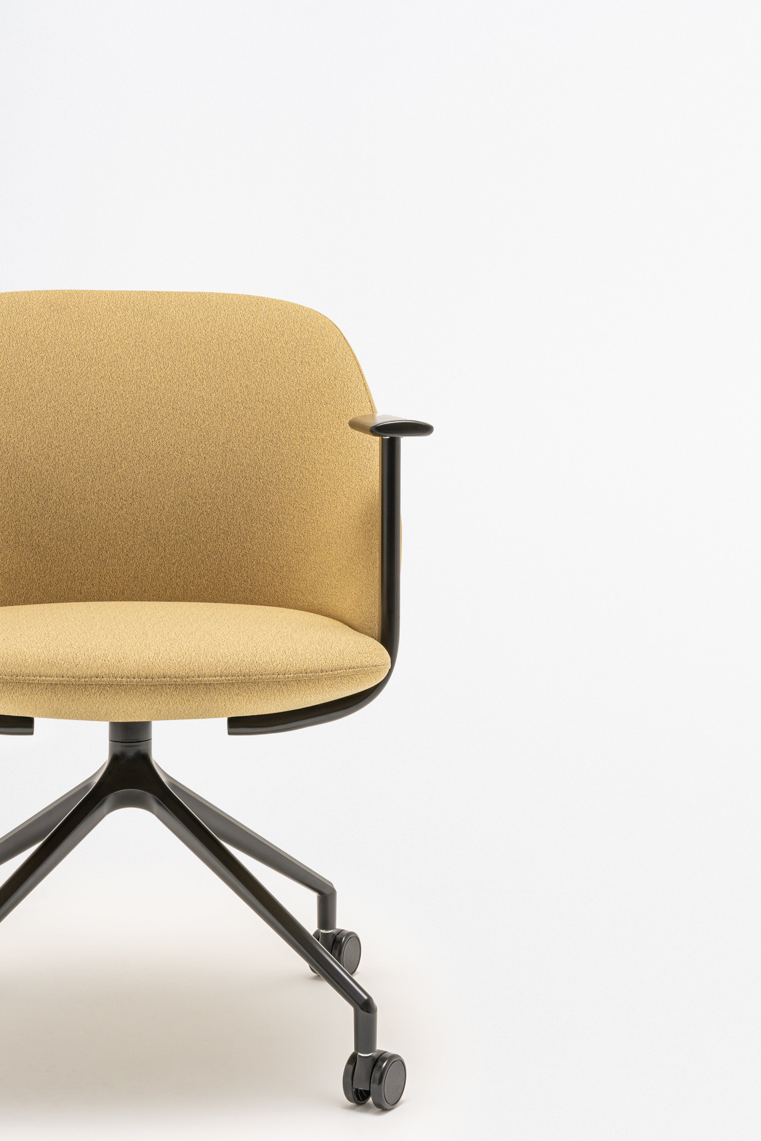 Rotable armchair with low backrest metal parallel base with wheels to a soft surface